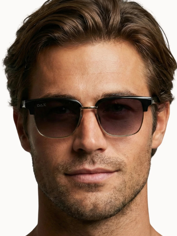 Man wearing dark sunglasses with a neutral background