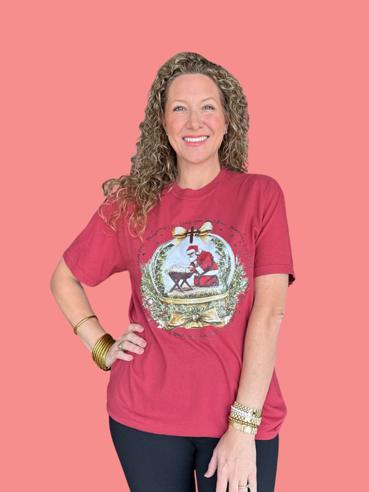 Woman wearing a red t-shirt with a graphic design on a pink background