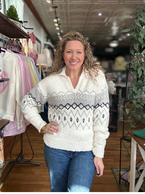 Woman wearing a patterned sweater in a clothing store