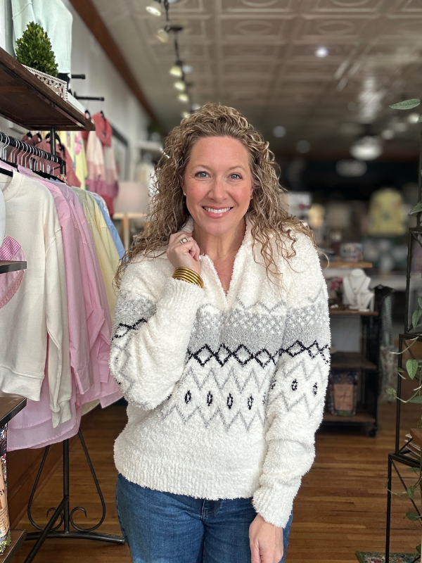 Woman wearing a patterned sweater in a clothing store