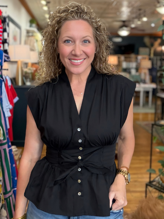 Woman wearing a black top in a store setting