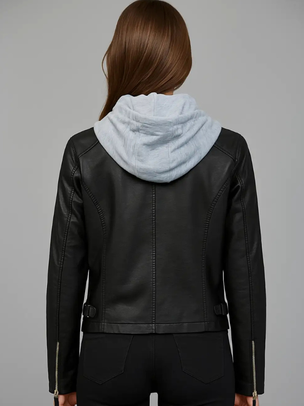 Person wearing a black leather jacket with a light blue hoodie underneath on a gray background