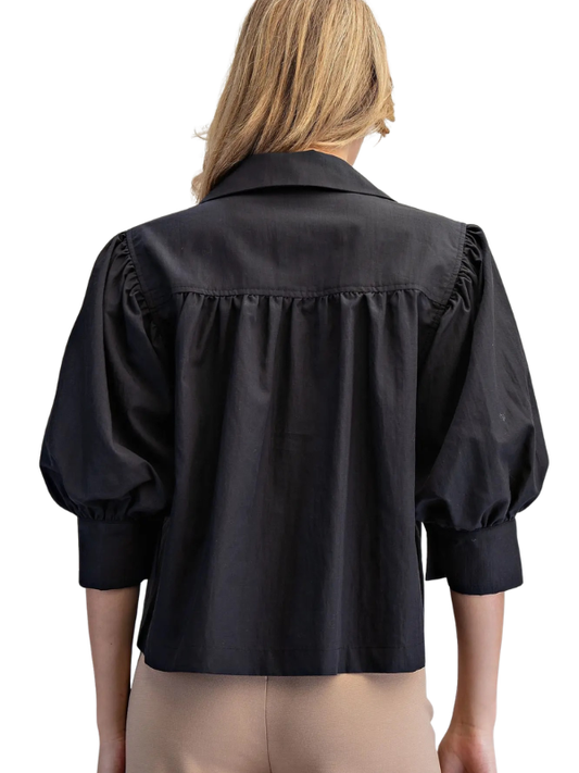 woman wearing a black puff sleeve top 