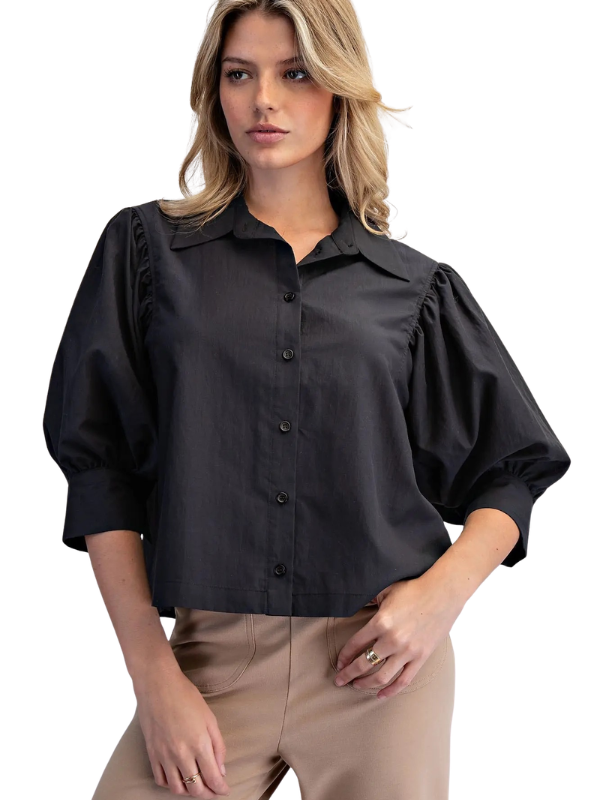 woman wearing a black puff sleeve top 