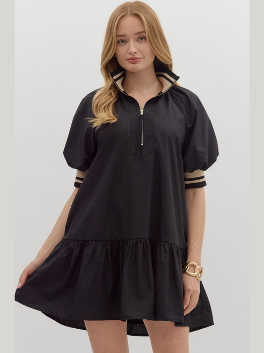 Woman wearing a black dress with striped sleeves on a white background