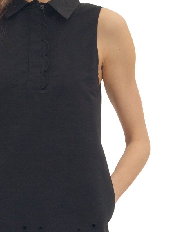 woman wearing a black eyelet dress