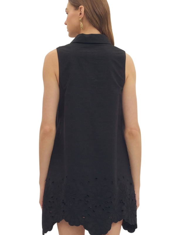 woman wearing a black eyelet dress