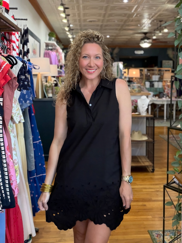 Woman wearing a black dress in a clothing store