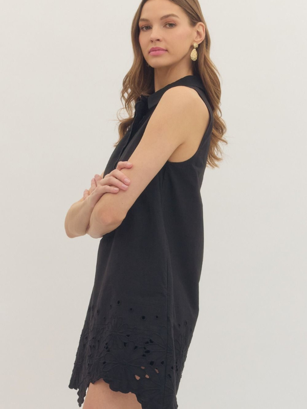 woman wearing a black eyelet dress