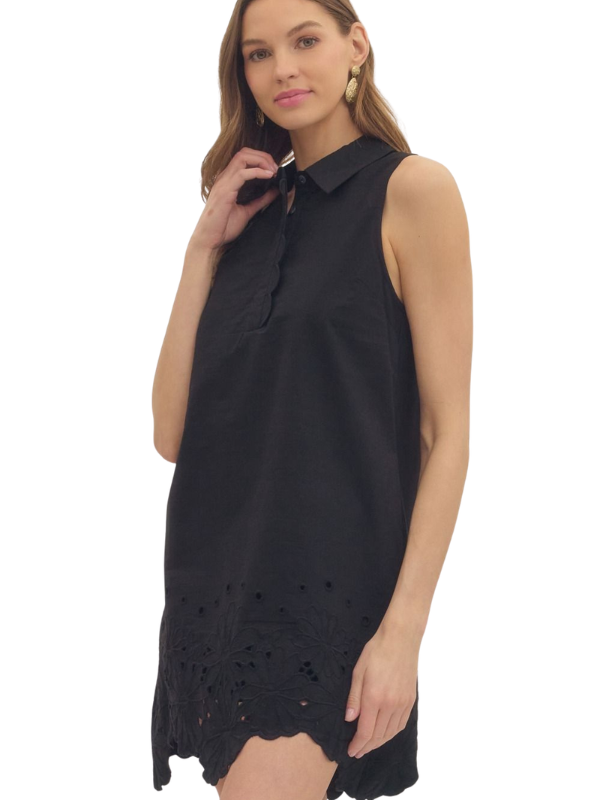 woman wearing a black eyelet dress