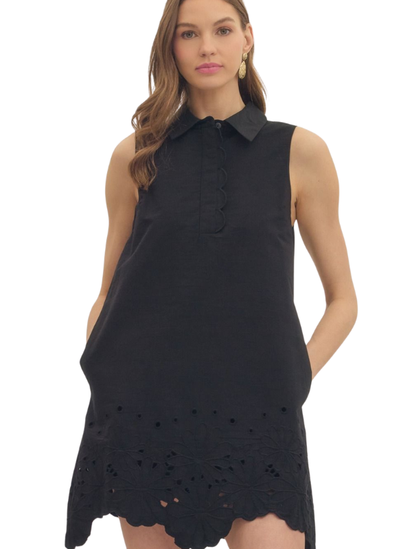 woman wearing a black eyelet dress