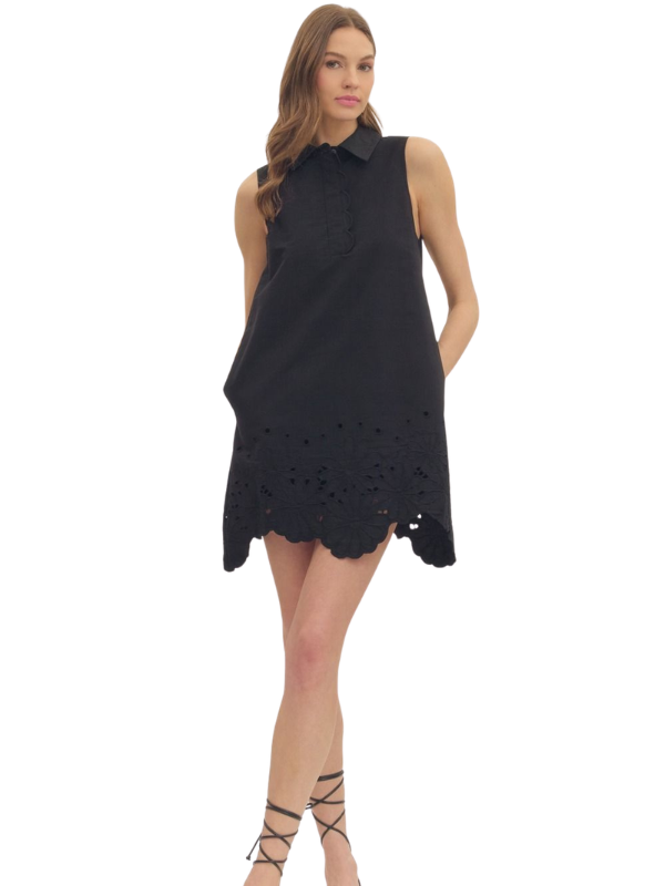 woman wearing a black eyelet dress