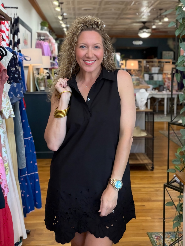 Woman wearing a black dress in a store setting