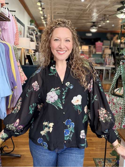 Woman wearing a floral blouse in a store setting