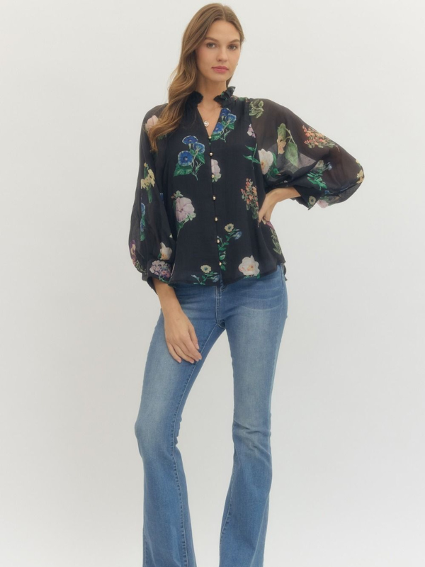 Woman wearing a floral blouse and blue jeans on a white background