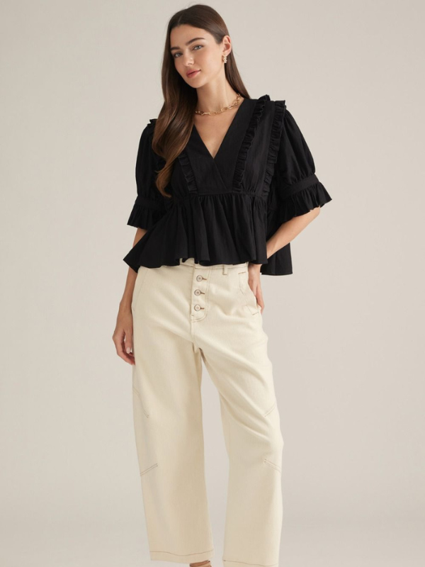 woman wearing a black top with khaki pants