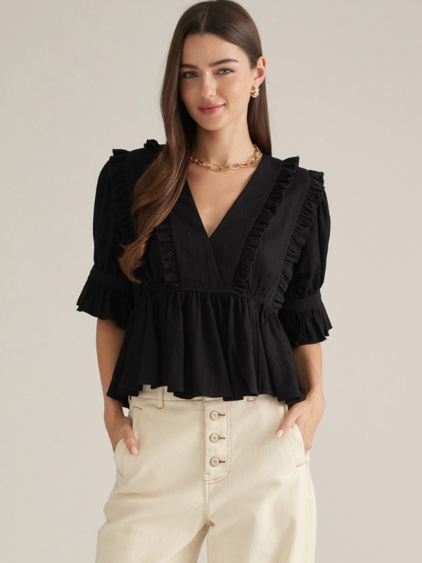 woman wearing a black top with khaki pants