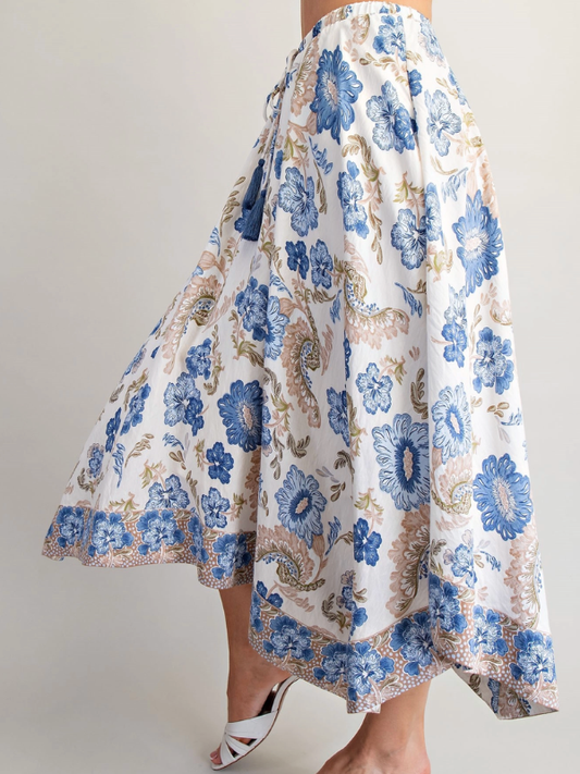 Floral skirt with blue and beige pattern on a plain background