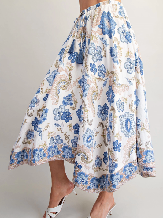 Floral patterned skirt with blue flowers on a plain background