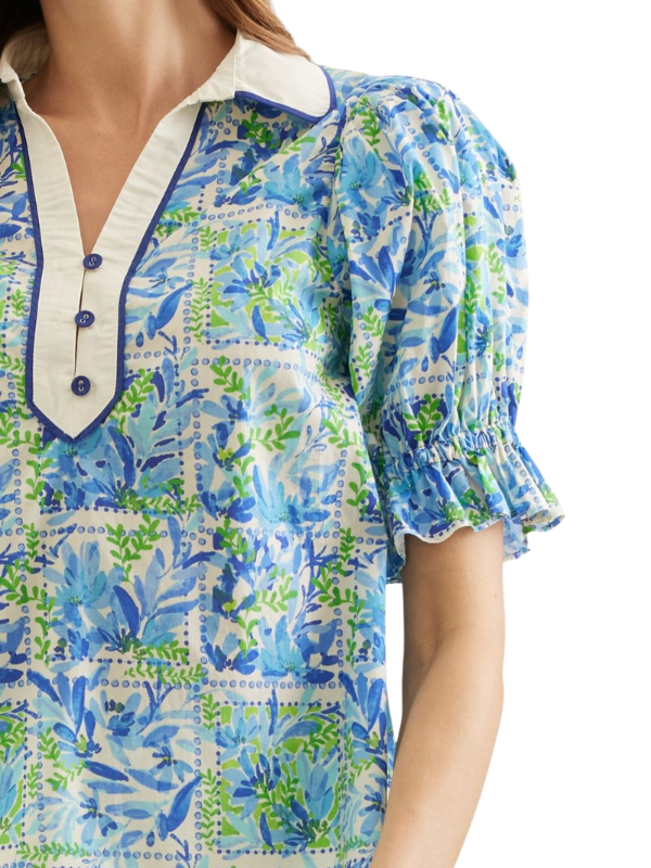Blue and green floral patterned blouse with white collar on a white background