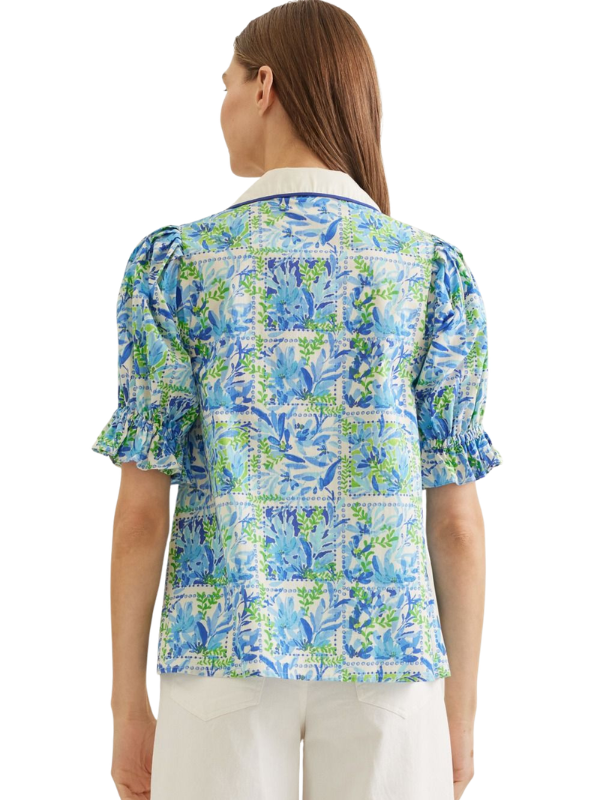 Woman wearing a blue floral blouse on a white background