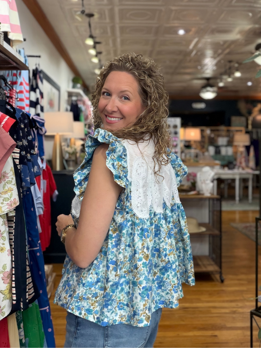 Woman wearing a floral blouse in a clothing store
