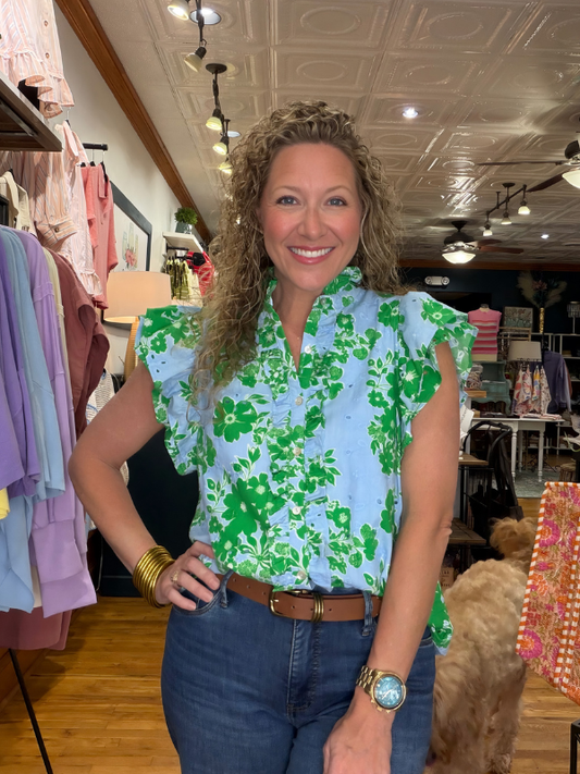 Woman wearing a floral blouse in a clothing store