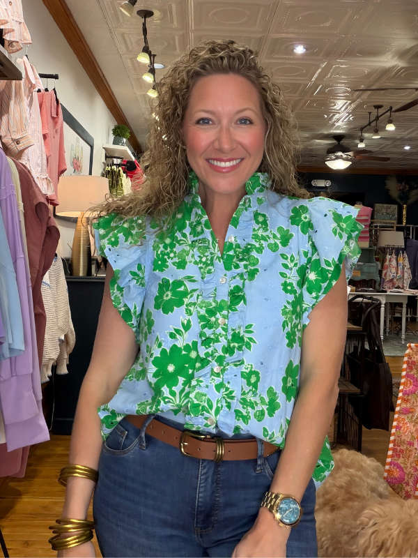 Woman wearing a floral blouse in a clothing store