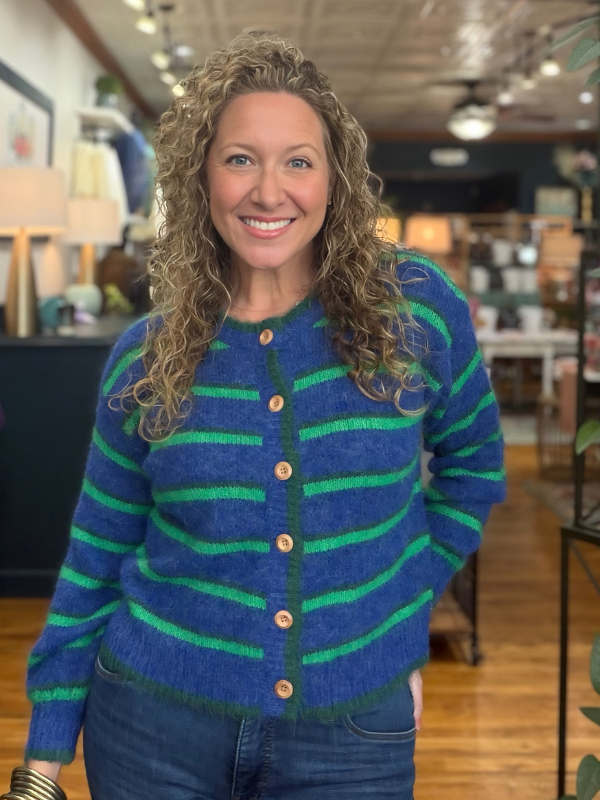 woman wearing a blue and green striped cardigan sweater 