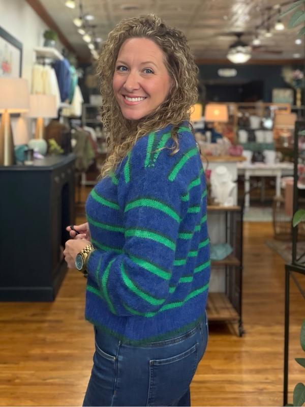 woman wearing a blue and green striped cardigan sweater 