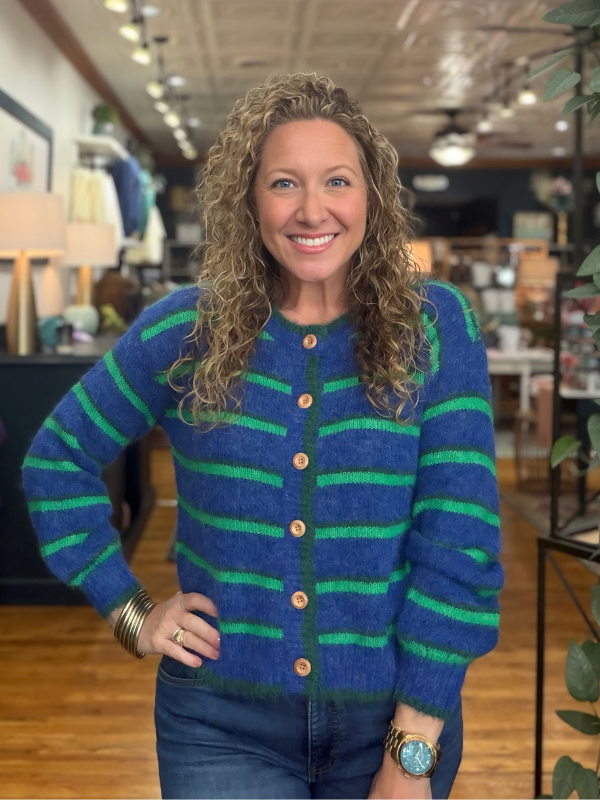 woman wearing a blue and green striped cardigan sweater 