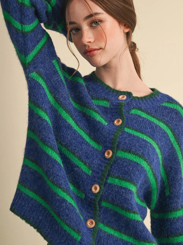 woman wearing a blue and green striped cardigan sweater 