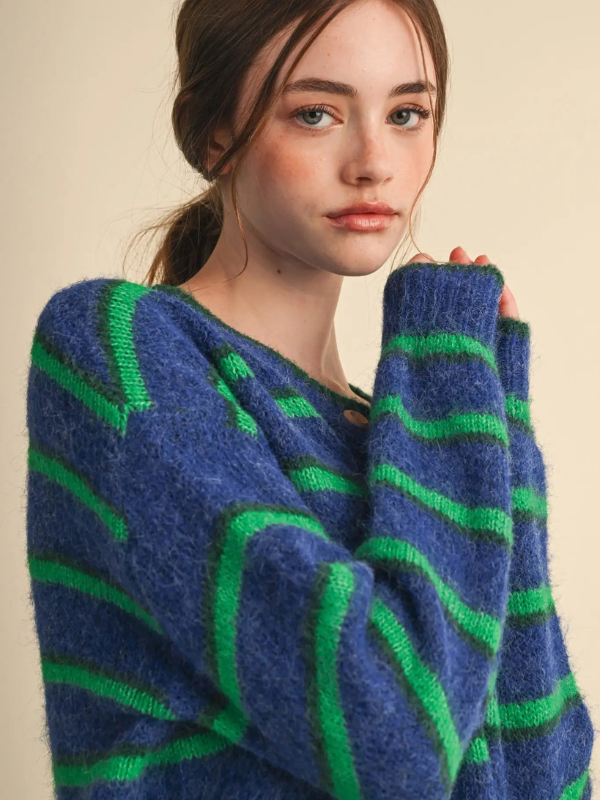 woman wearing a blue and green striped cardigan sweater 