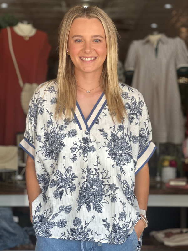 Woman wearing a floral blouse in a clothing store
