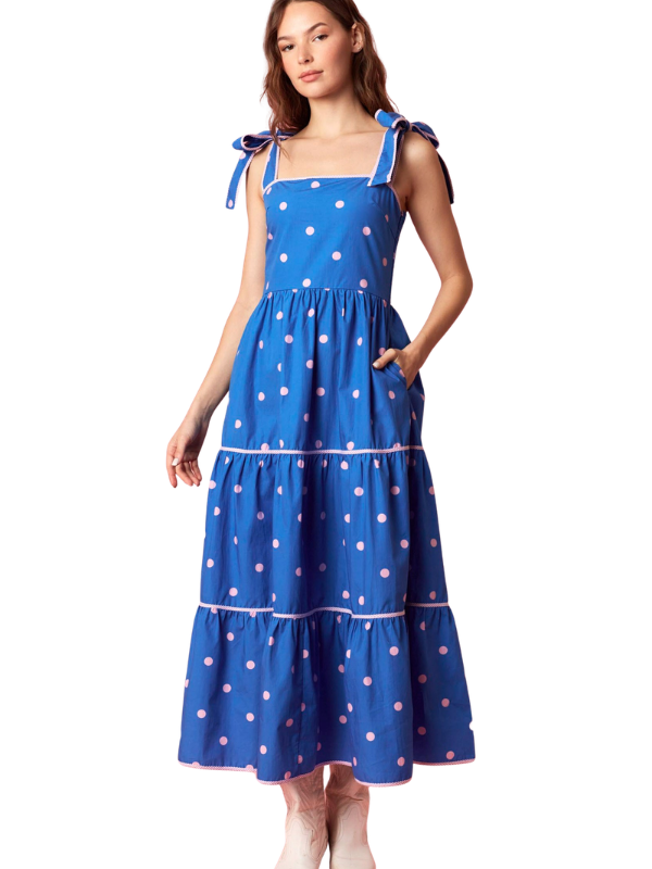 woman wearing a blue and pink polka dot dress 