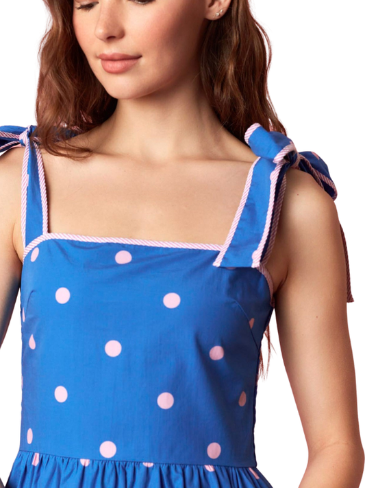 woman wearing a blue and pink polka dot dress 
