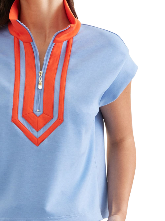 Light blue top with orange zipper detail on a white background