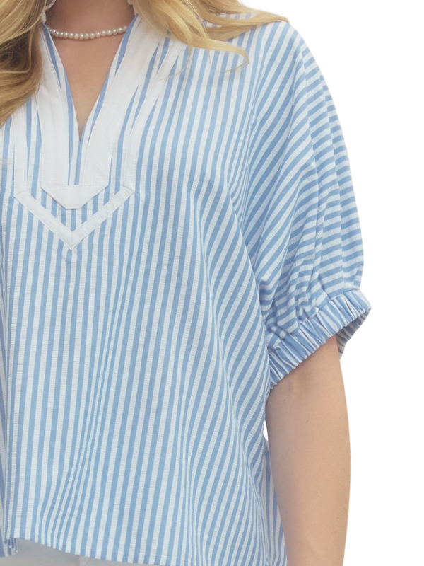 Blue and white striped shirt worn by a person on a white background