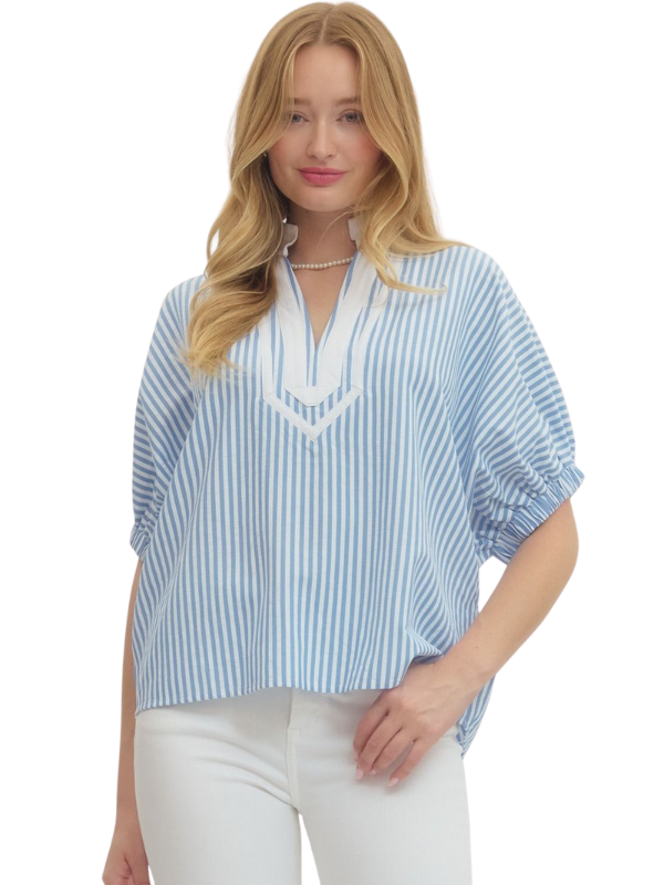 Woman wearing a blue and white striped blouse on a white background