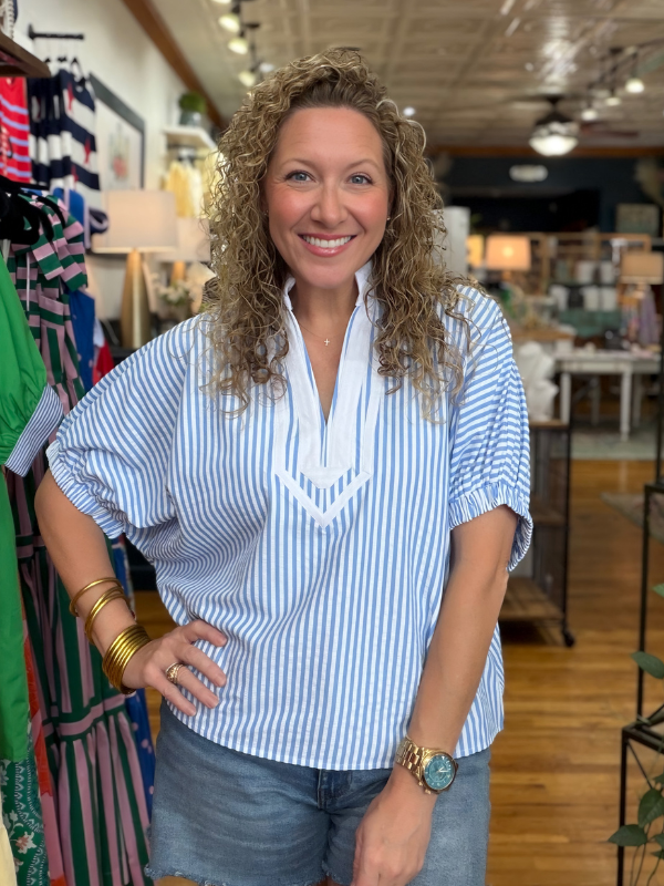 woman wearing blue and white striped top in a store