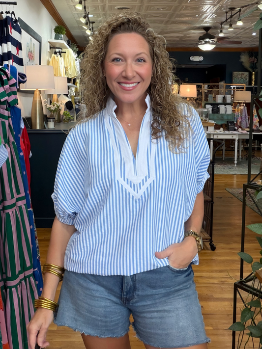 woman wearing blue and white striped top in a store