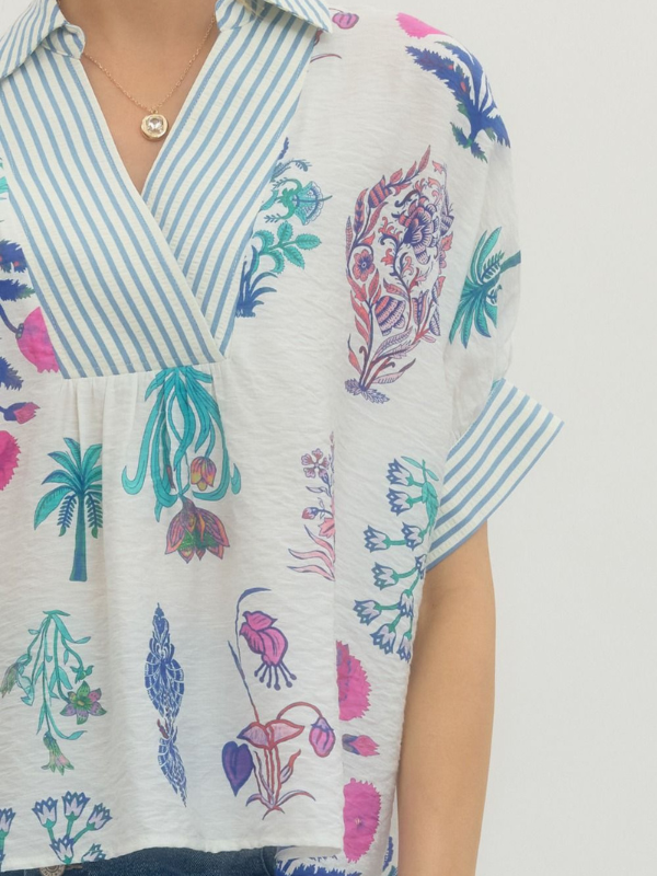 Colorful floral and abstract patterned shirt with a neutral background