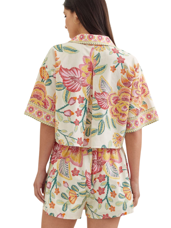 woman wearing a matching botanical top and skort 