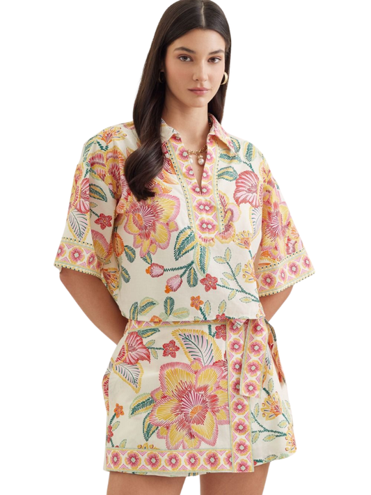 woman wearing a matching botanical top and skort 