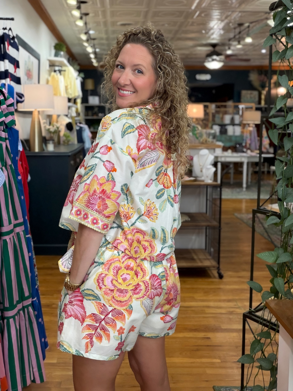 Woman wearing a floral dress in a store setting