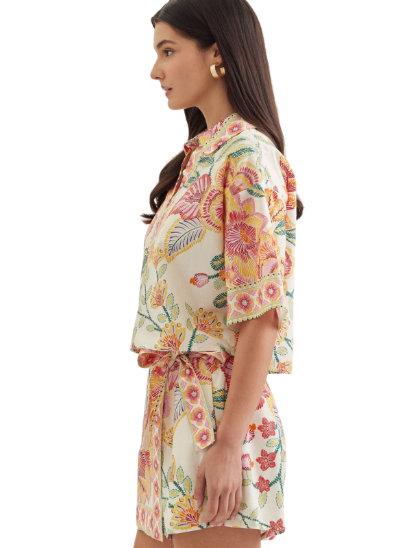 woman wearing a matching botanical top and skort 