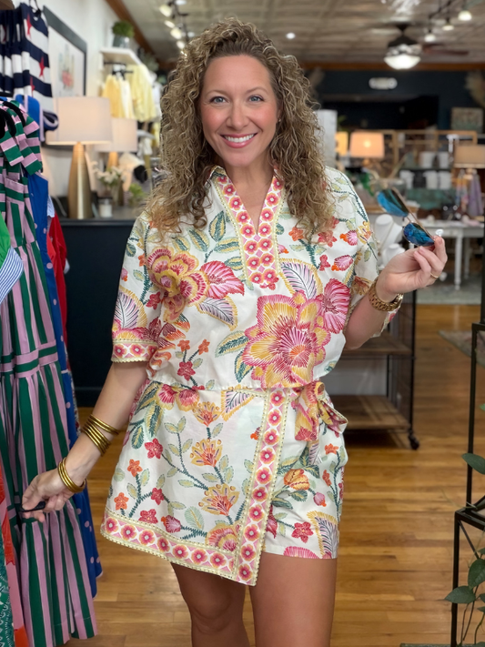 Woman wearing a floral dress in a store setting