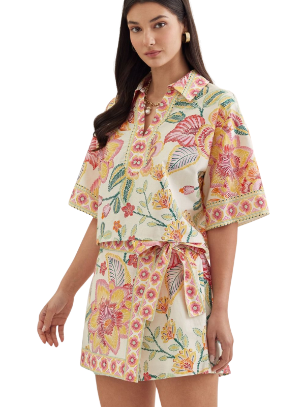 woman wearing a matching botanical top and skort 