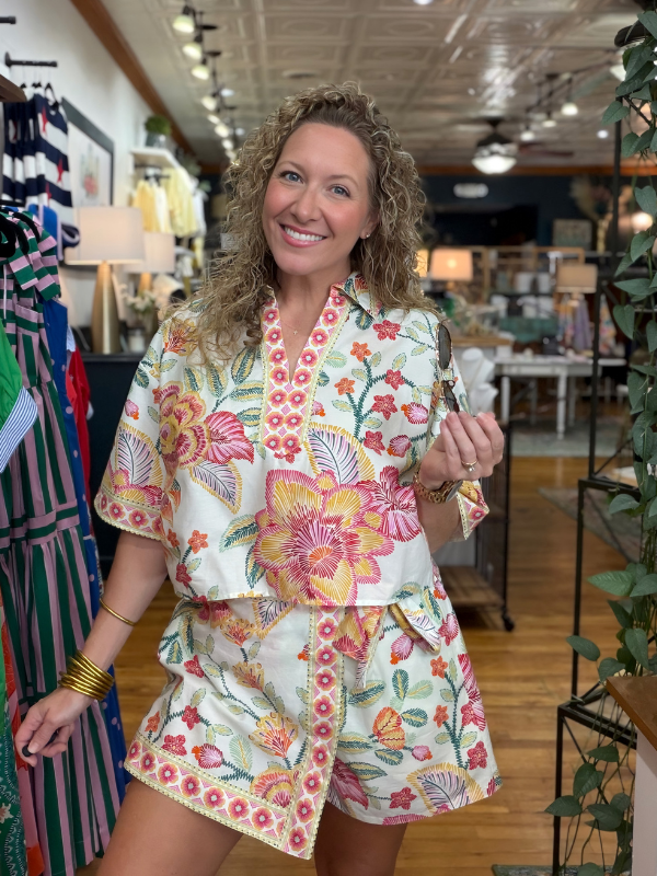 Woman wearing a floral outfit in a store setting