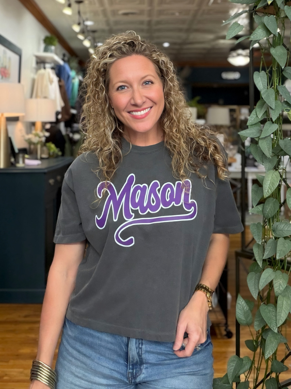 woman wearing a boxy grey tee that says Mason 
